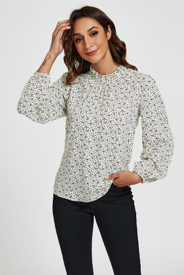 Top met hoge hals en kleine bloemenprint en ruches in wit